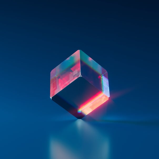 translucent cube resting on a reflective surface